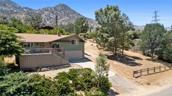 an aerial view of a house with a yard and lake view