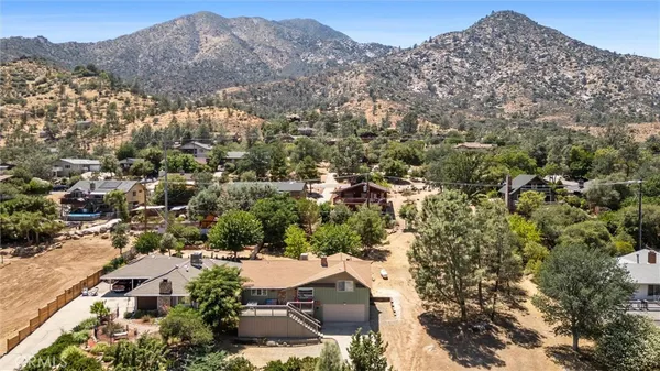 an aerial view of residential house and sandy dunes