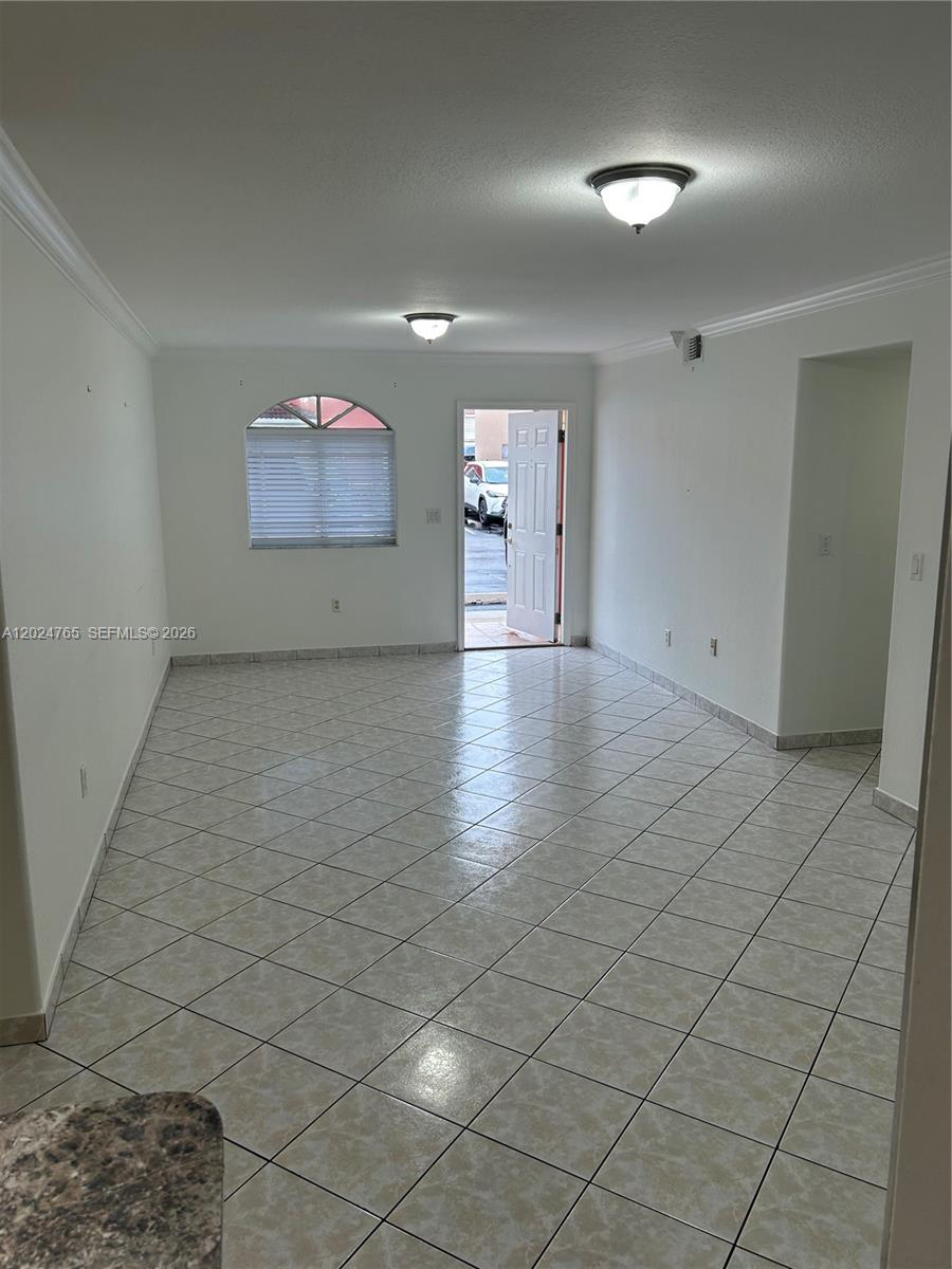 10919 West Okeechobee Road, Unit 101 Hialeah Gardens, FL 33018 - Photo 21 of 21 an empty room with wooden floor