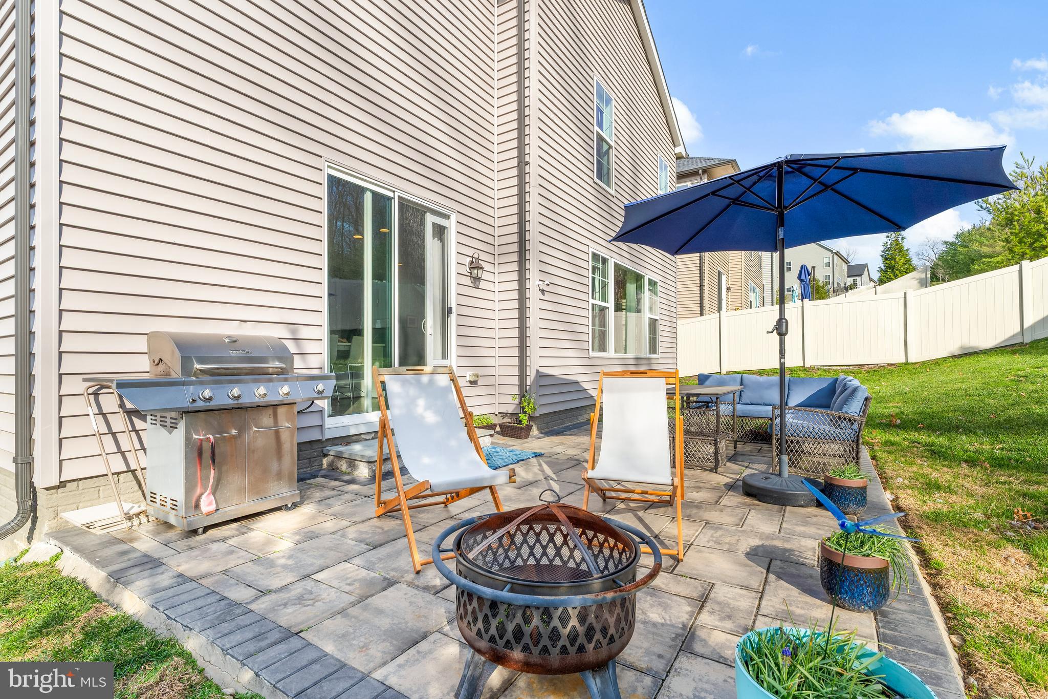9915 Arapahoe Road New Market, MD 21774 - Photo 49 of 81 a view of a patio with a table and chairs under an umbrella