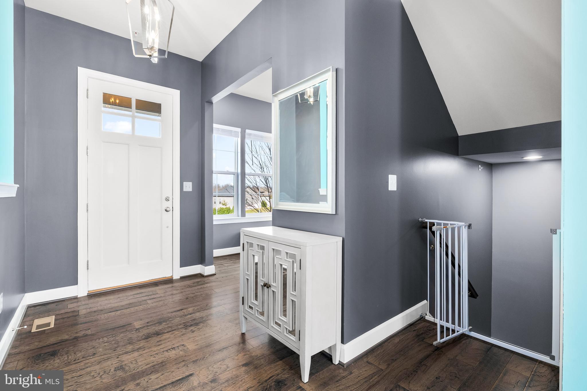 9915 Arapahoe Road New Market, MD 21774 - Photo 7 of 81 a view of a hallway with wooden floor and staircase
