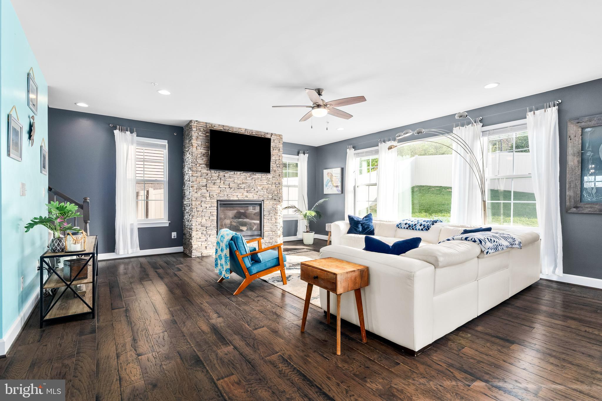 9915 Arapahoe Road New Market, MD 21774 - Photo 10 of 81 a living room with fireplace furniture and a flat screen tv