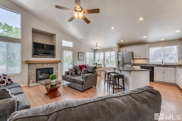 a living room with furniture a fireplace and a flat screen tv