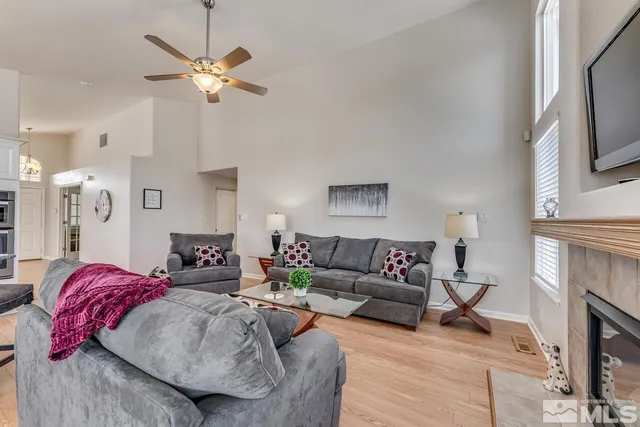 a living room with furniture a fireplace and a flat screen tv