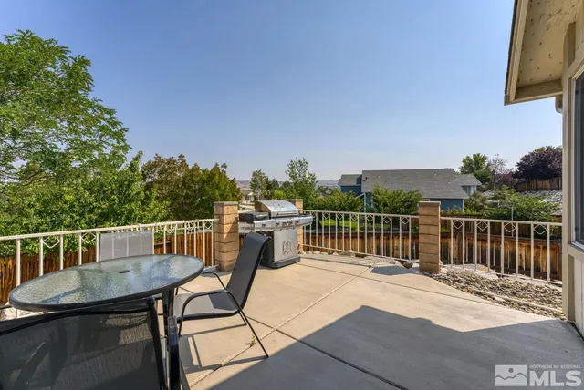 a view of a balcony with two chairs and a table