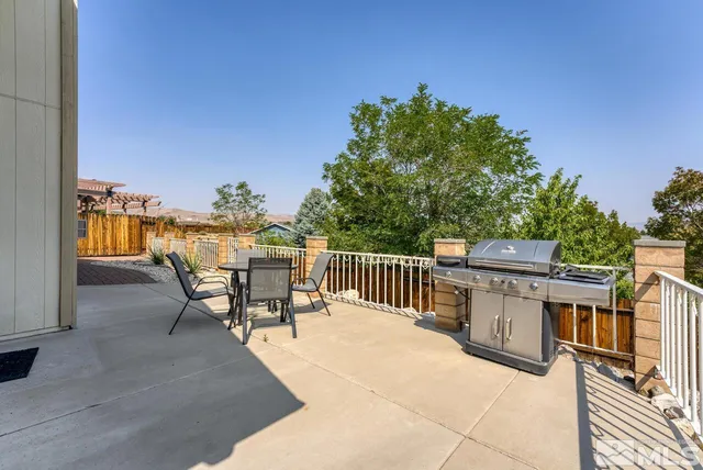 a view of a patio with a table and chairs