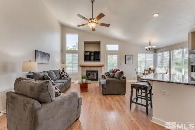 a living room with fireplace furniture and a wooden floor