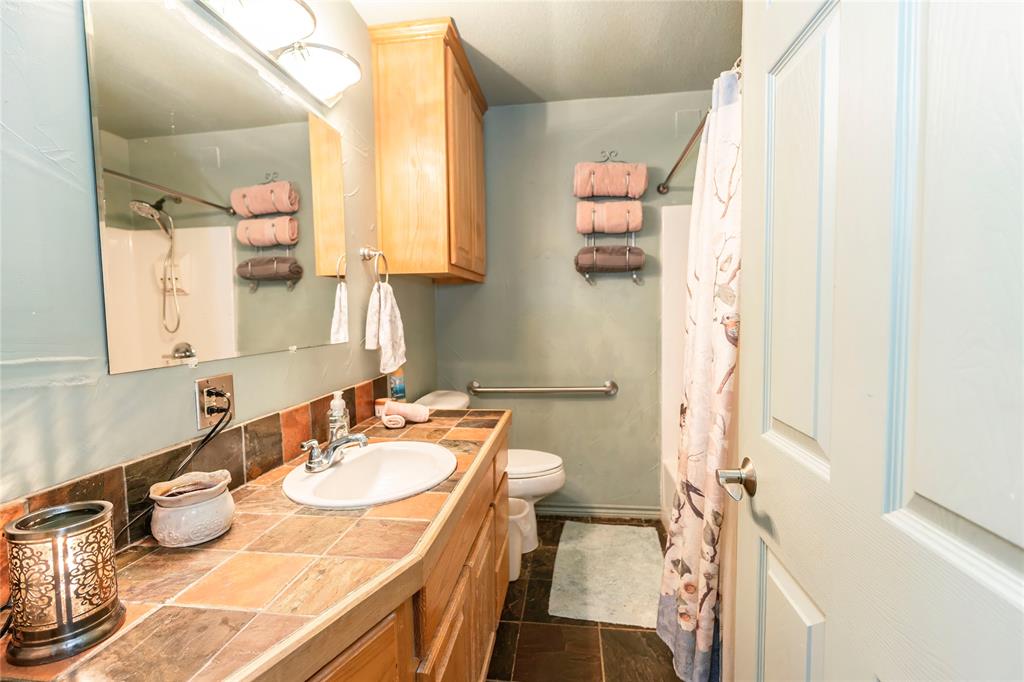698 Storey Road Nocona, TX 76255 - Photo 19 of 34 Full bath featuring vanity and a shower with shower curtain