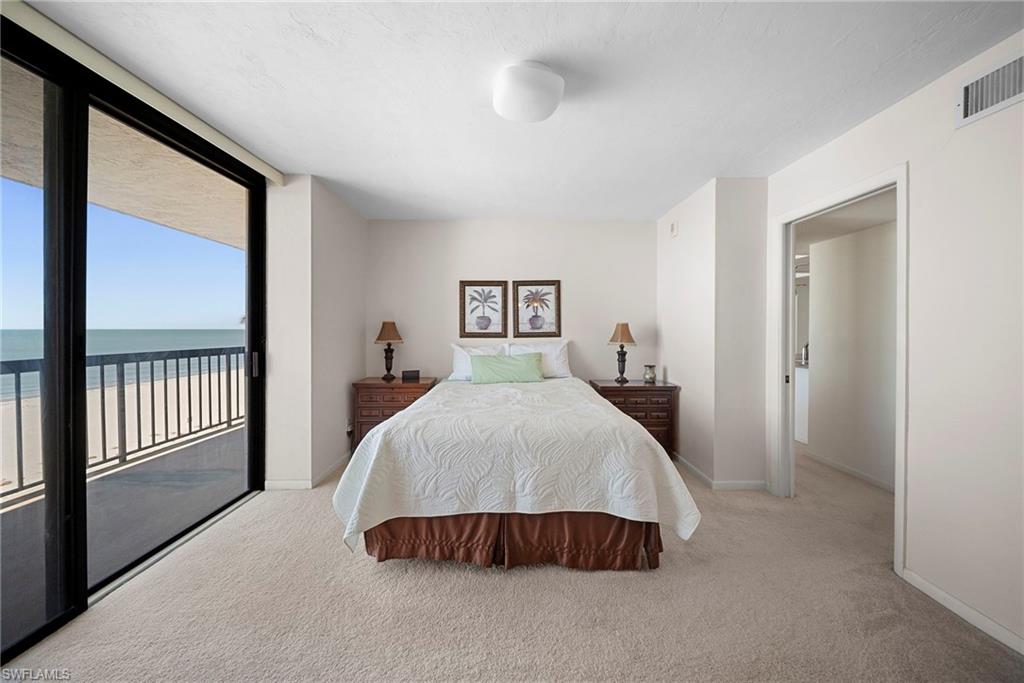 26300 Hickory Boulevard, Unit 503 Bonita Springs, FL 34134 - Photo 21 of 50 Bedroom with light carpet, access to exterior, and a water view