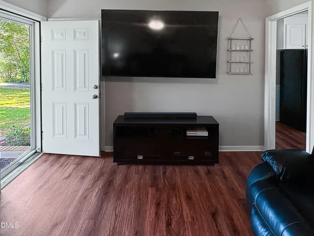 a living room with a flat screen tv and a fireplace