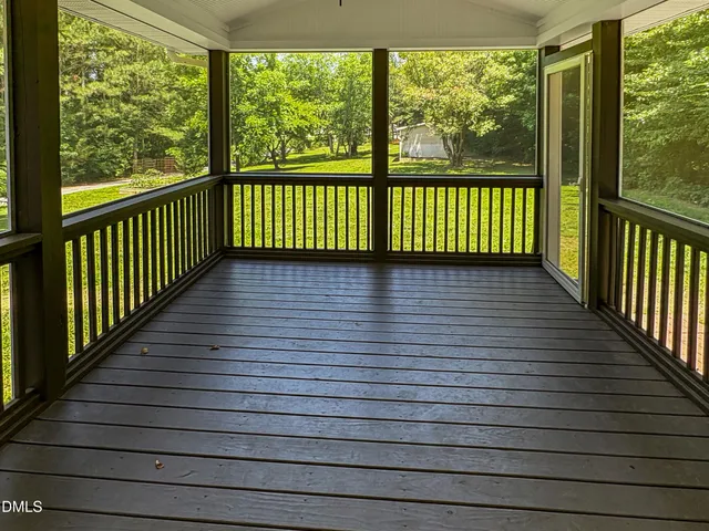 a view of a balcony with wooden floor