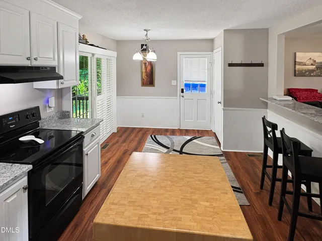 a kitchen with stainless steel appliances granite countertop a refrigerator a stove and a refrigerator