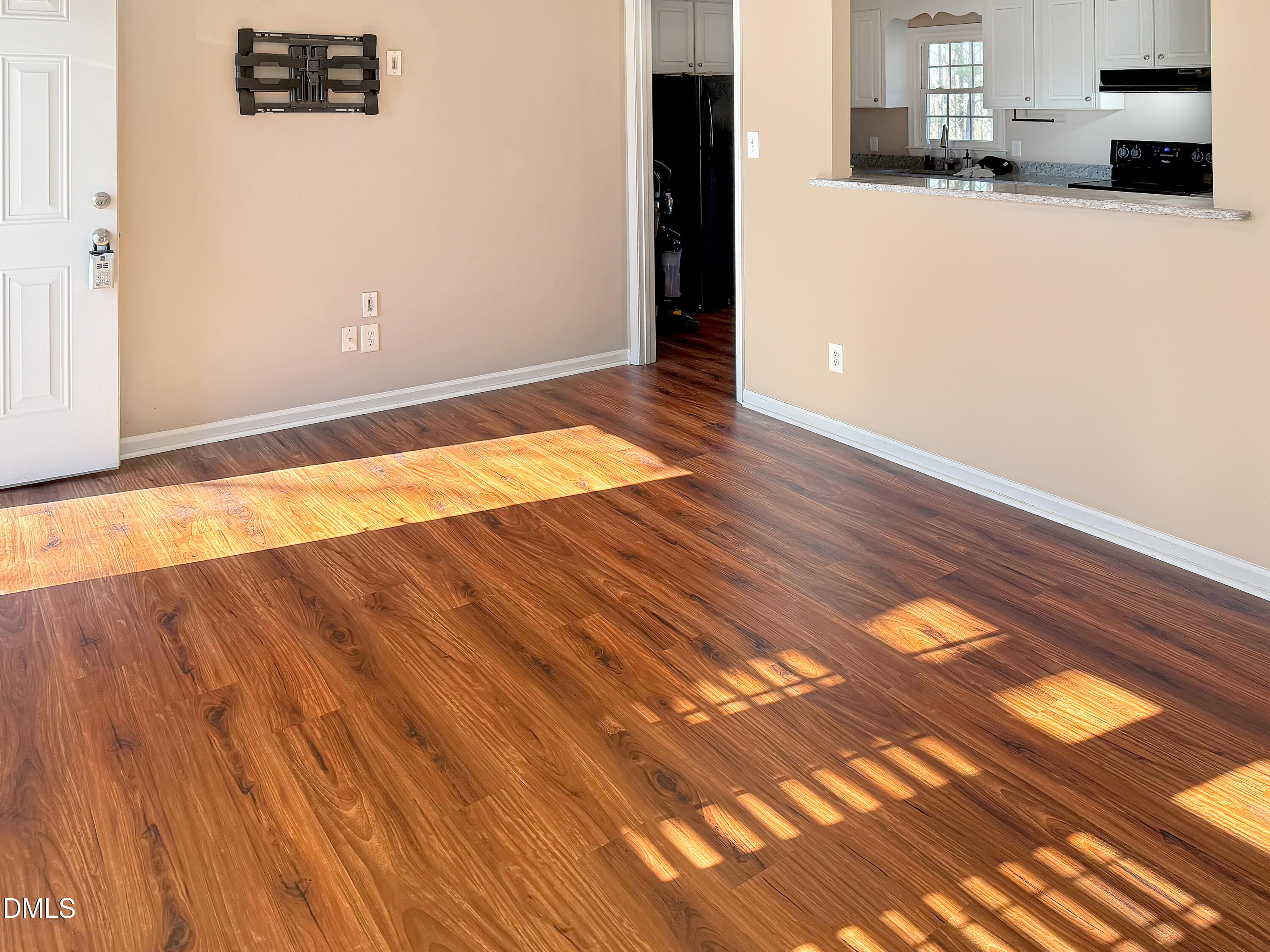 573 Arnold Road Louisburg, NC 27549 - Photo 9 of 16 an empty room with wooden floor and windows