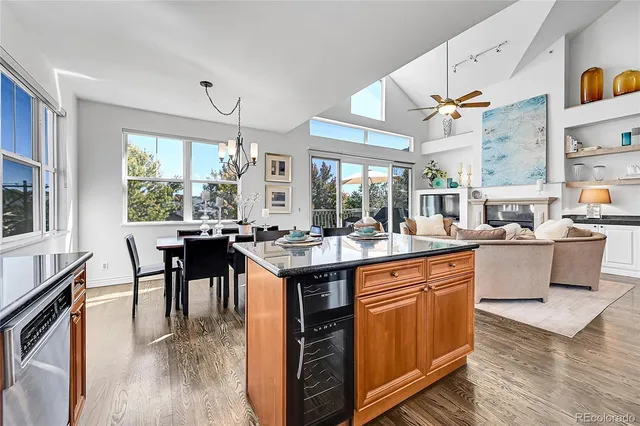 a kitchen with stainless steel appliances granite countertop table chairs and a large window