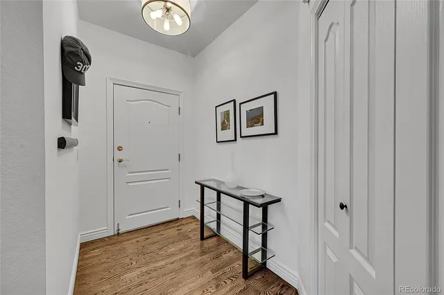 a view of a hallway with wooden floor and entryway
