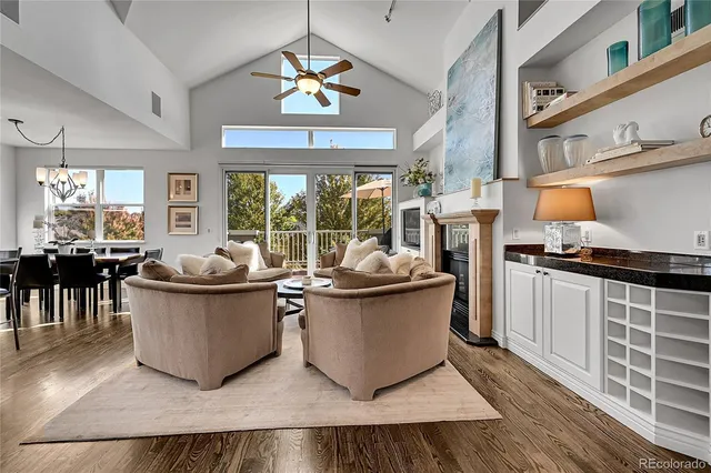 a living room with furniture and a kitchen view