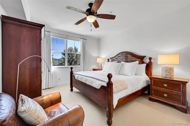 a bedroom with a bed couch and window