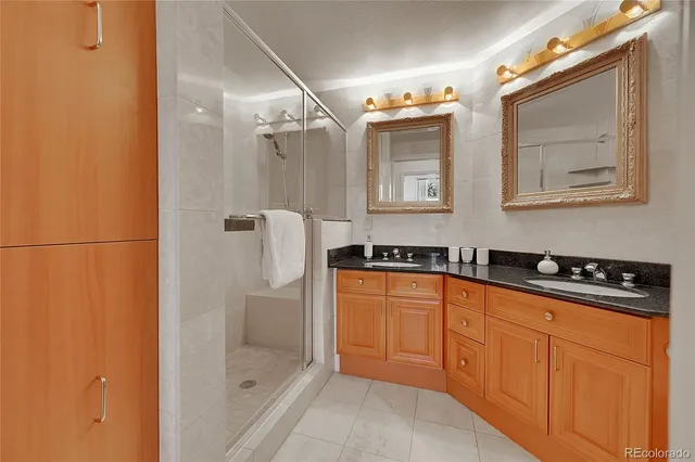 a bathroom with a sink a mirror and a shower