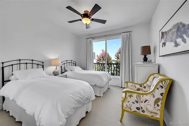 a bedroom with two beds and painting on the wall