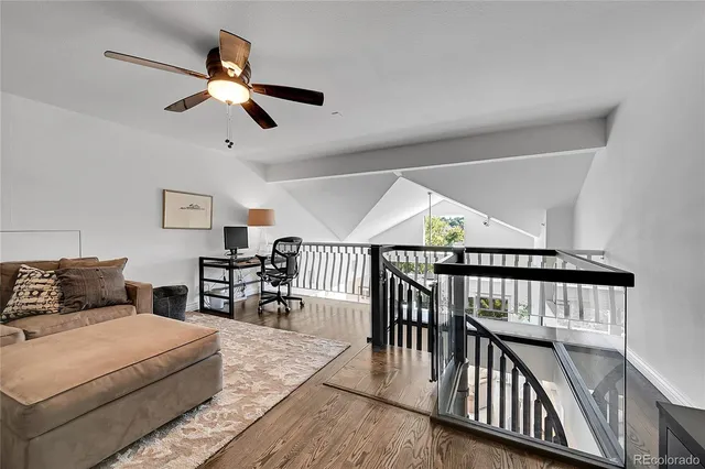 a bedroom with furniture and a large window