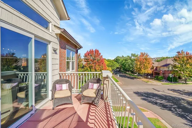 a balcony with wooden floor and city view