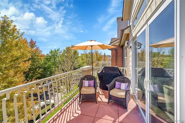 a view of a chair and tables in the balcony