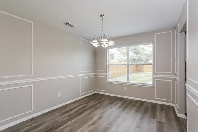 a kitchen with kitchen island granite countertop a stove sink and cabinets