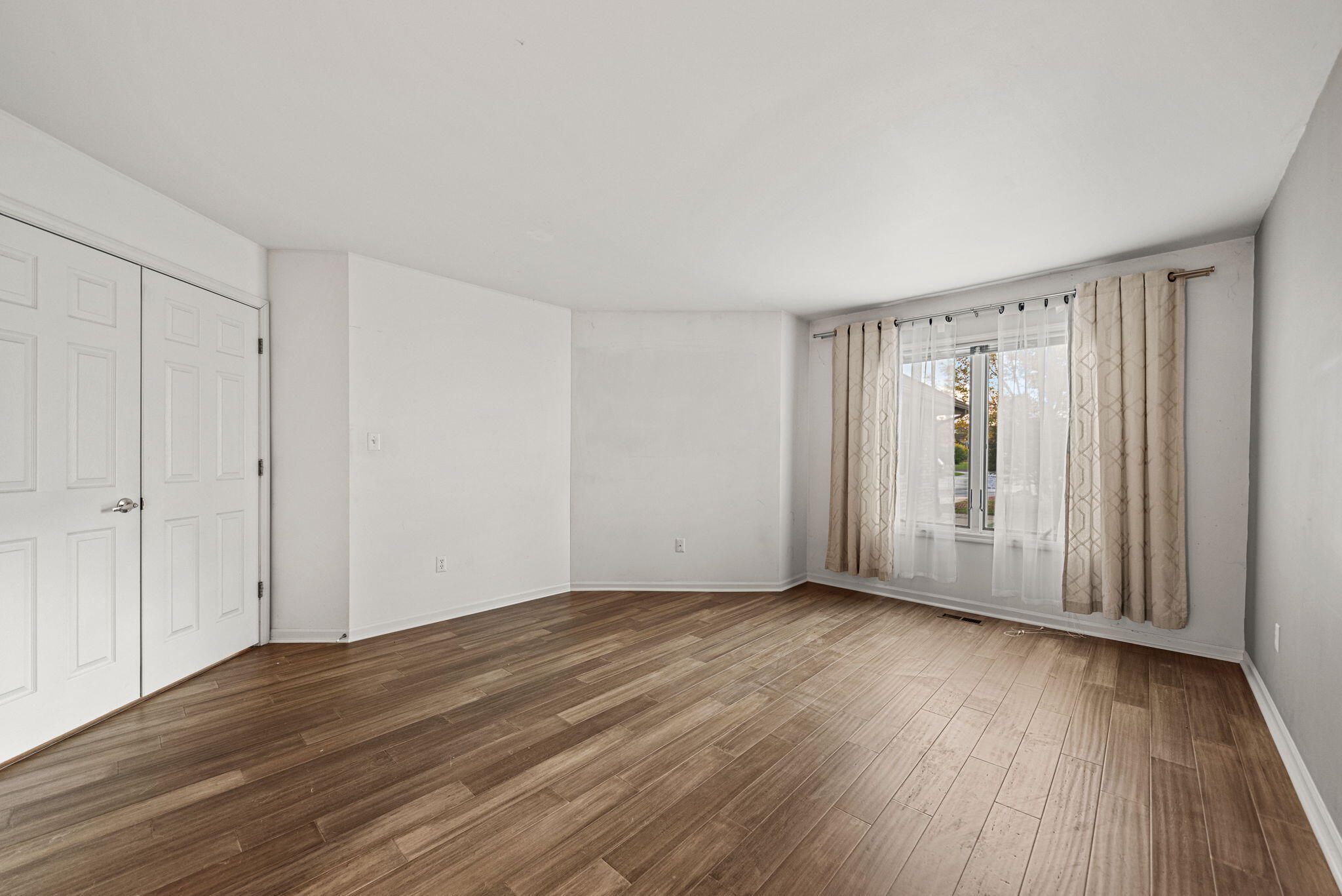 1345 West 94th Court Crown Point, IN 46307 - Photo 11 of 20 a view of an empty room with wooden floor and a window