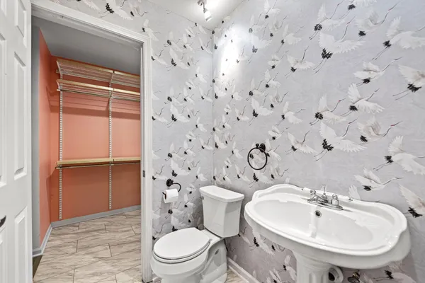 a white toilet sitting next to a bathroom sink