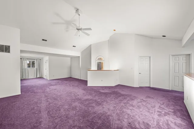 a view of empty room with ceiling fan