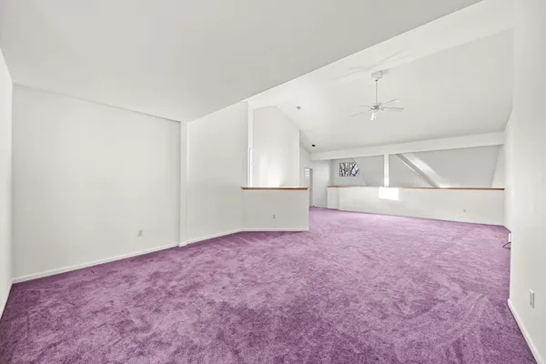 an empty room with closet and windows