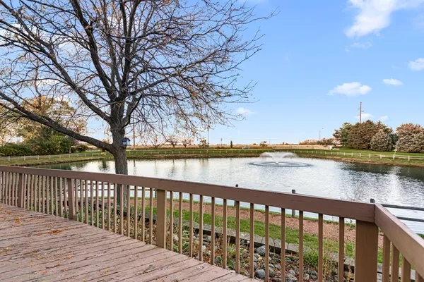 a balcony with wooden floor and lake view
