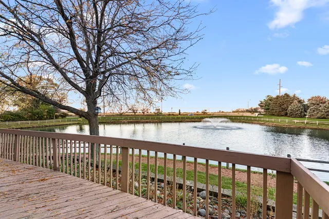 a balcony with wooden floor and lake view