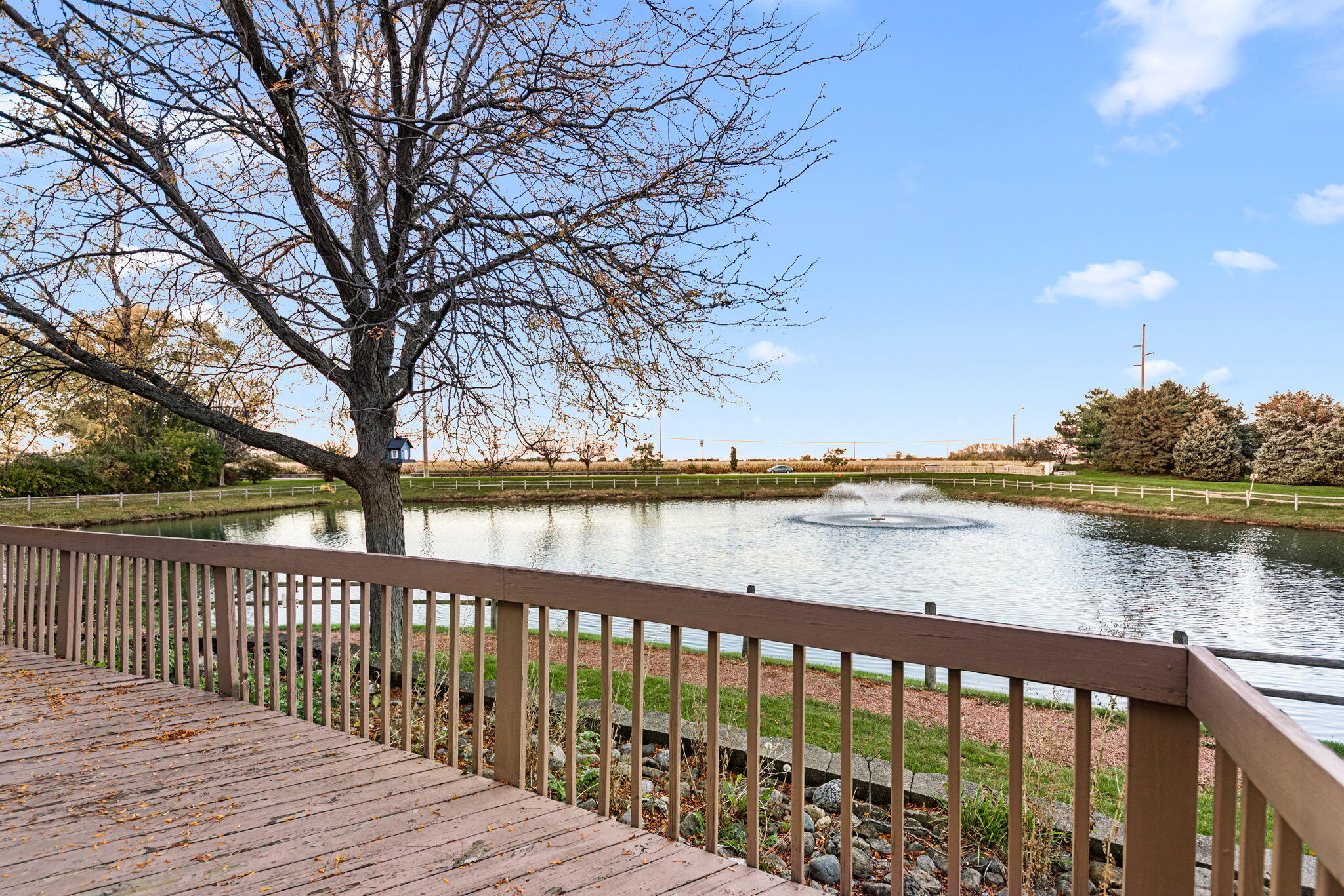 1345 West 94th Court Crown Point, IN 46307 - Photo 2 of 20 a balcony with wooden floor and lake view