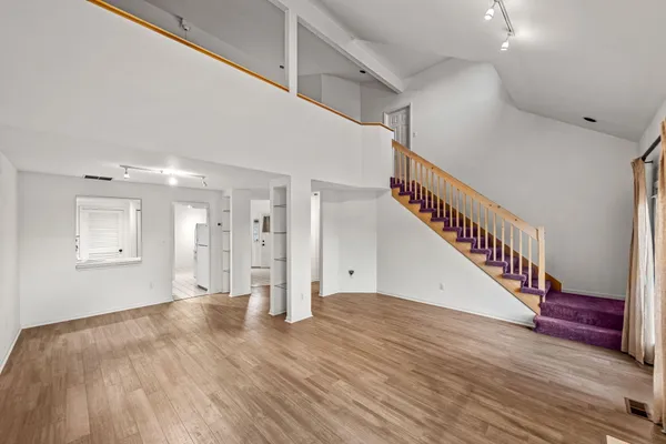 a view of entryway and hall with wooden floor