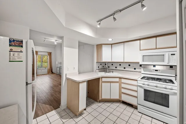 a kitchen with a stove sink and cabinets