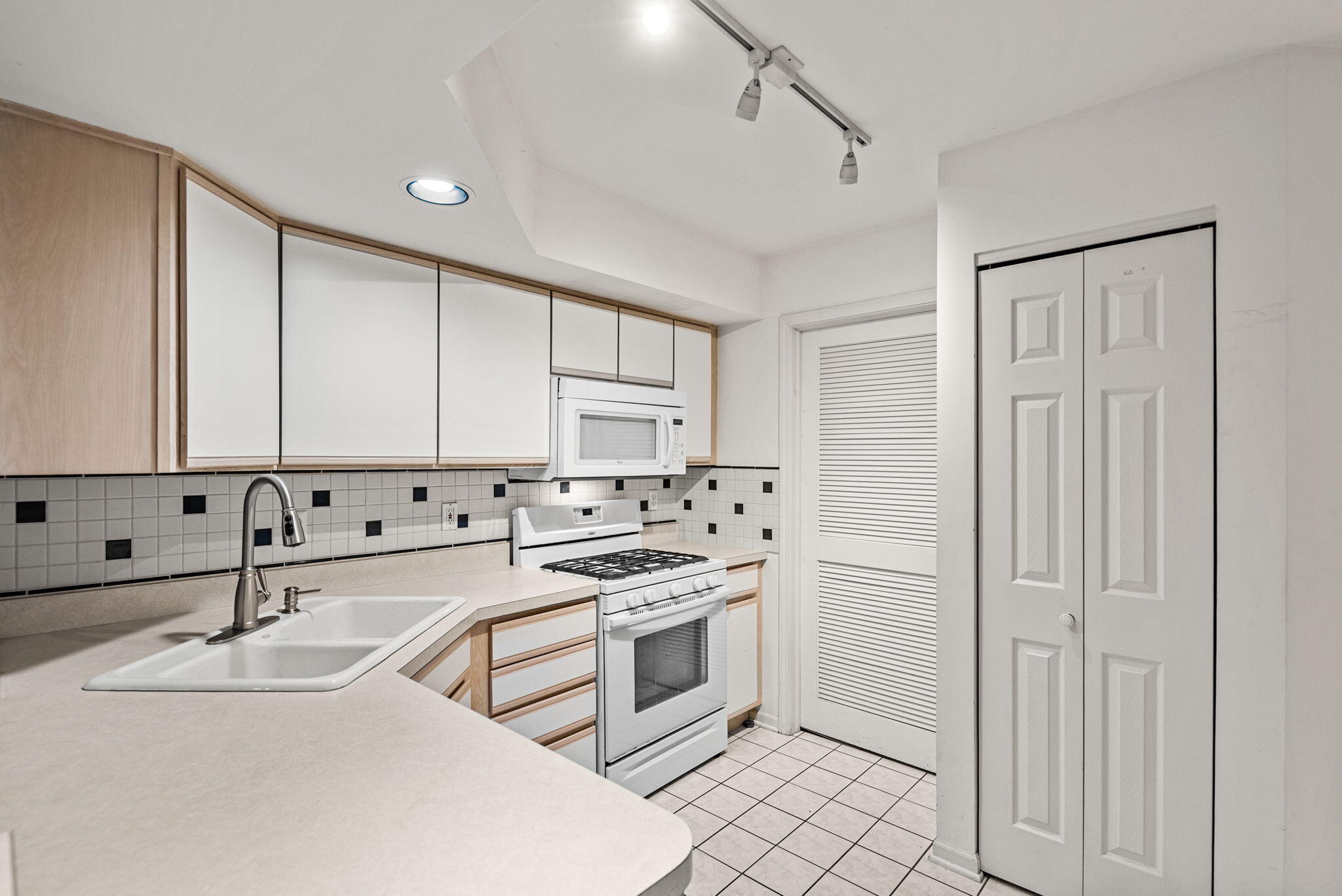 1345 West 94th Court Crown Point, IN 46307 - Photo 9 of 20 a kitchen with granite countertop a sink stove and cabinets