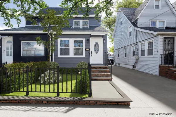 a view of a house with a small yard and plants