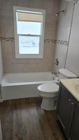 a bathroom with a toilet a sink and bathtub