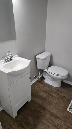 a white toilet sitting next to a bathroom sink