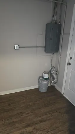 a view of empty room with wooden floor