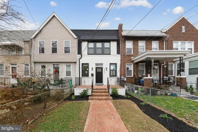 a front view of a house with a yard table and chairs