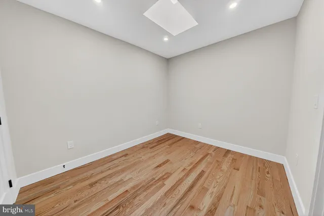 a view of room with wooden floor and white walls
