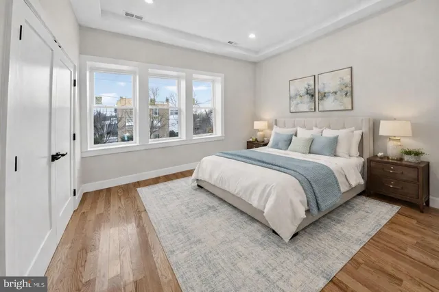 a spacious bedroom with a bed and a large window