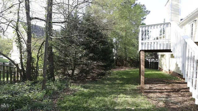 a sign board with tall trees