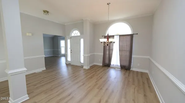 a view of a room with wooden floor and a window