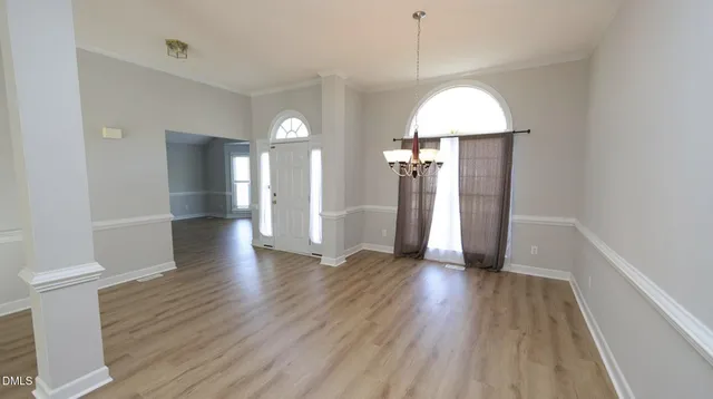 a view of a room with wooden floor and a window