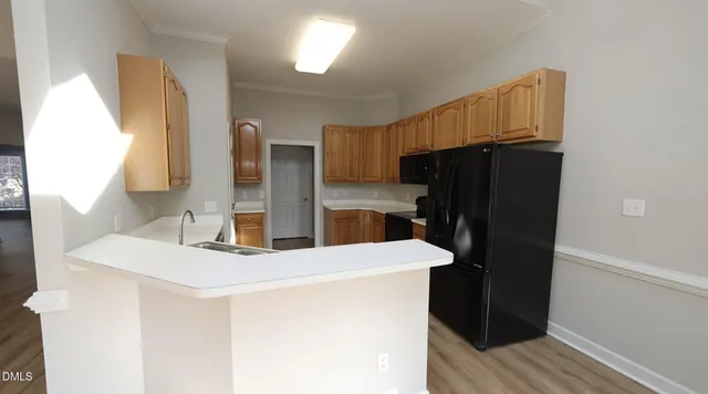 a kitchen with stainless steel appliances a refrigerator and a stove