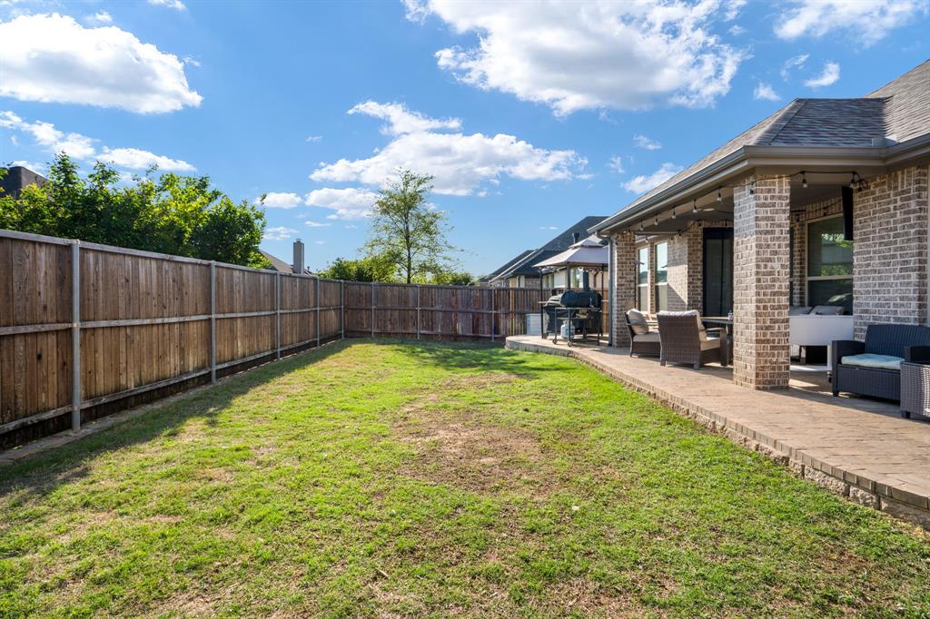 1501 Snowdrop Drive Prosper, TX 75078 - Photo 10 of 27 a view of a backyard with a garden