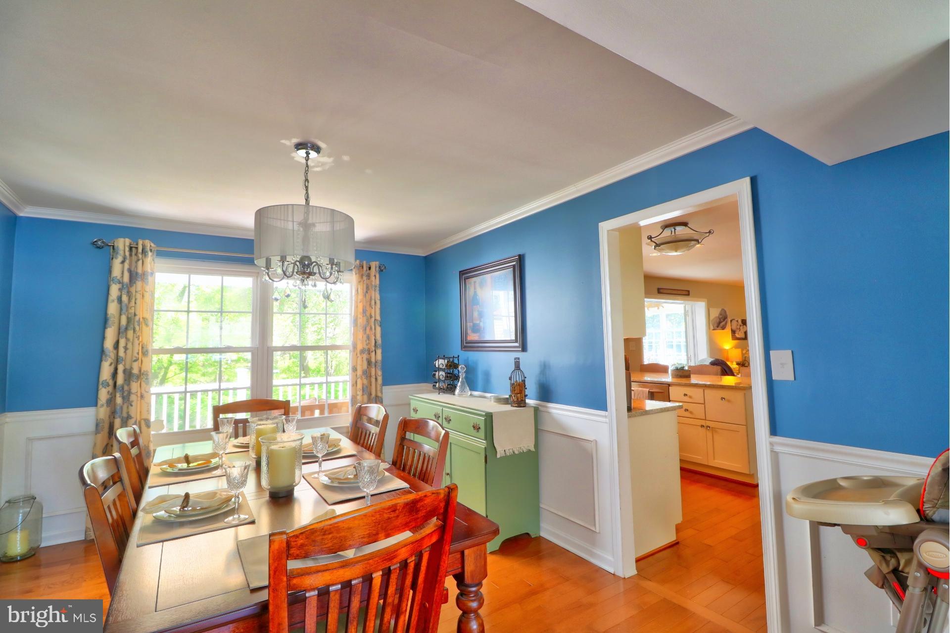 4701 Vicky Road Baltimore, MD 21236 - Photo 13 of 39 a view of a dining room with furniture a chandelier and wooden floor